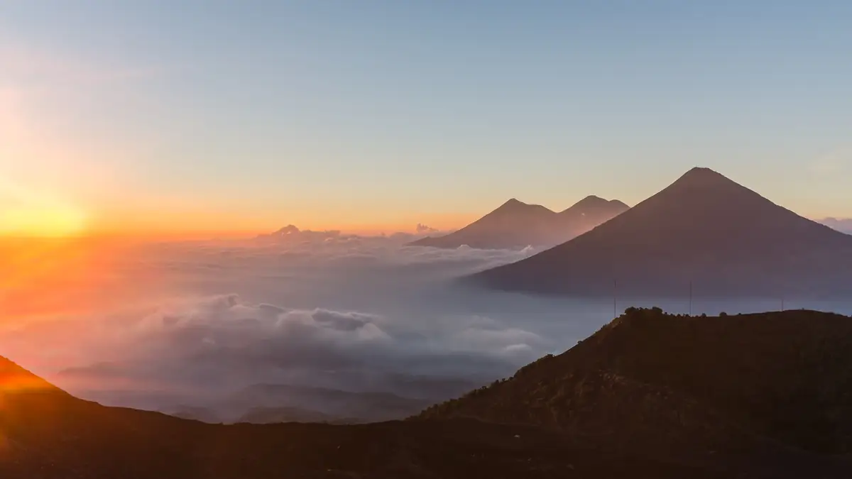 Sonnenaufgang über dem Wolkenmeer mit Agua, Acatenango und Fuego, gesehen vom Pacaya