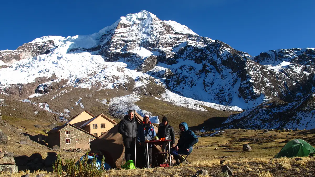 Trekking group at the camp below Ausangate, with hut and tents