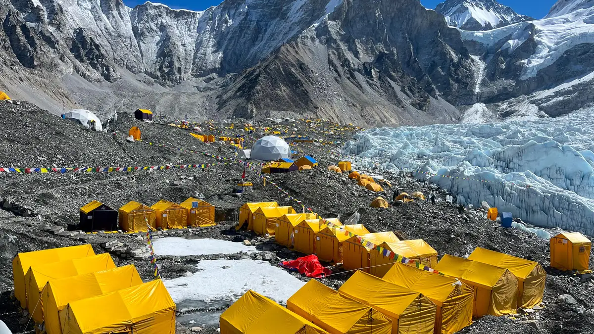 Yellow expedition tents at Everest Base Camp in front of the Khumbu Icefall