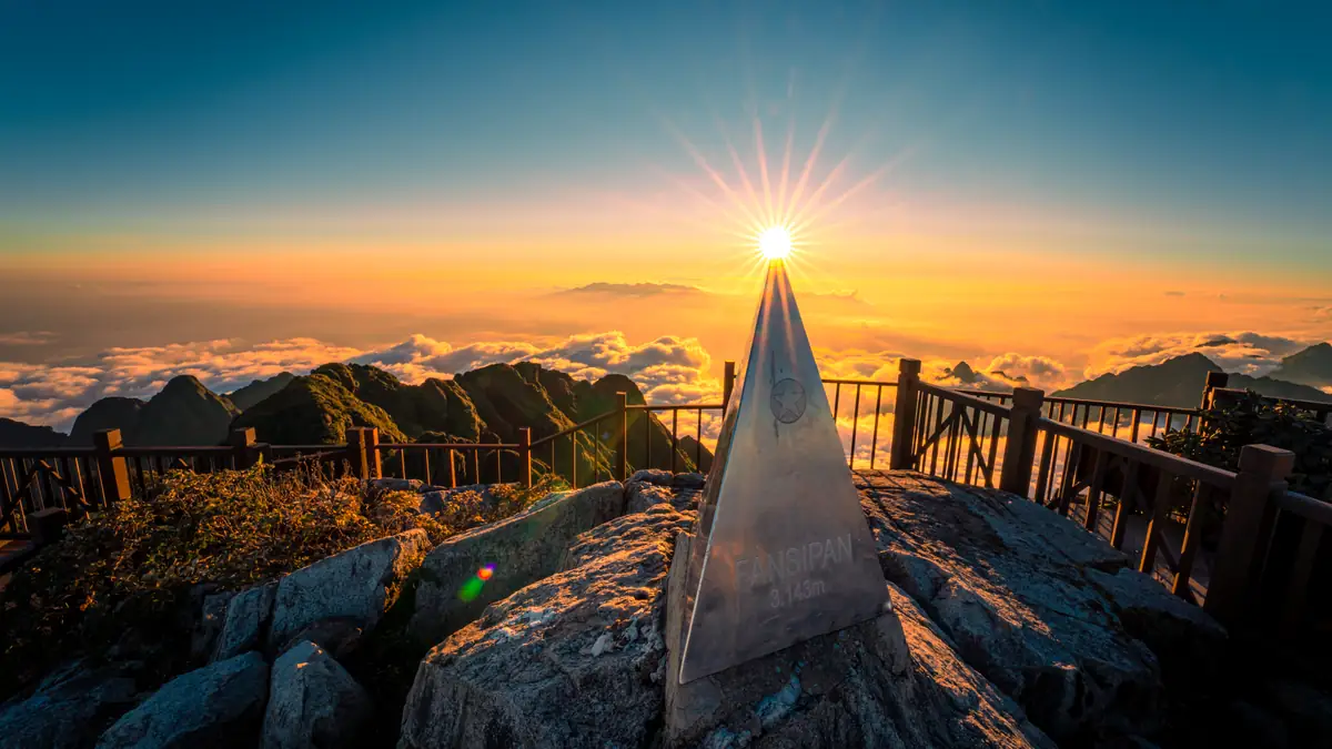 The summit pyramid of Fansipan, 3,143 m, above a sea of clouds at sunset