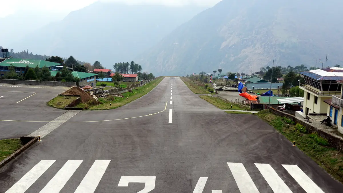 The sloping runway at Lukla with the hillside at its end