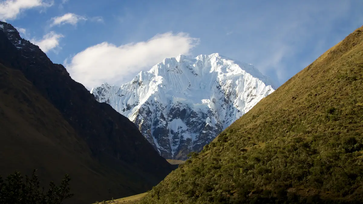 Horses and hikers on the way to the Salkantay pass, the glaciated Salkantay behind