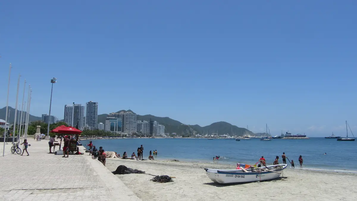 The bay of Santa Marta with beach, boats and the city behind