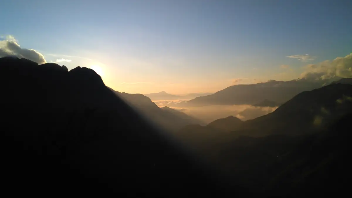 Sun rays over the Hoang Lien Son mountains in morning mist