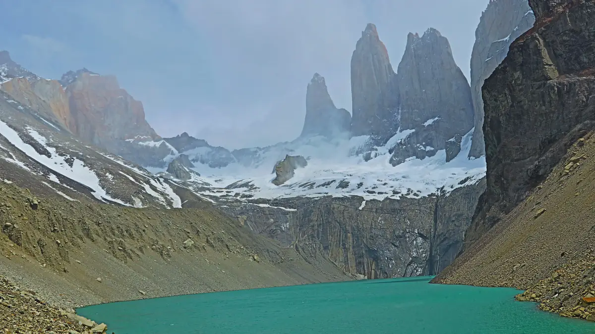 The three granite towers of Torres del Paine above the turquoise lagoon at the Base Torres lookout